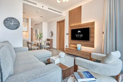 a living room with two couches and a tv at STAY BY LATINEM Luxury 1BR Holiday Home CB 2001 Near Burj Khalifa in Dubai