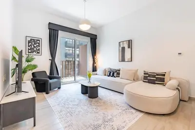 a living room with a couch and a tv at Contemporary 1Bedroom Escape in Eaton Place in Dubai