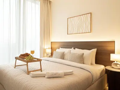 a bedroom with a large bed with a table on it at Forte Suites by Prestige Nest in Dubai