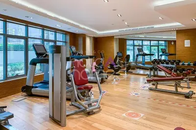 a gym with treadmills and exercise equipment in a building at Elegant Studio apartment in Avanti Tower Business Bay in Dubai