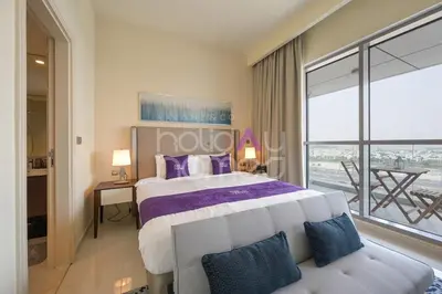 a bedroom with a large bed and a couch at Elegant Studio apartment in Avanti Tower Business Bay in Dubai