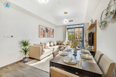 a living room with a couch and a table at Cozy 2-BR at Belgravia Square in Dubai