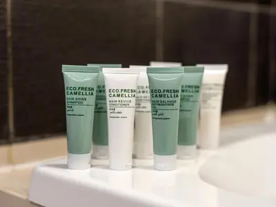 a group of four bottles of sunscreen on a counter at Luxury Stay in Downtown-Steps to Burj & Dubai Mall in Dubai