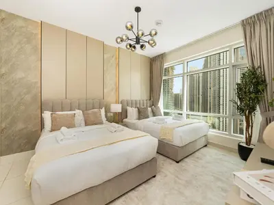 a bedroom with two beds and a large window at Luxury Stay in Downtown-Steps to Burj & Dubai Mall in Dubai