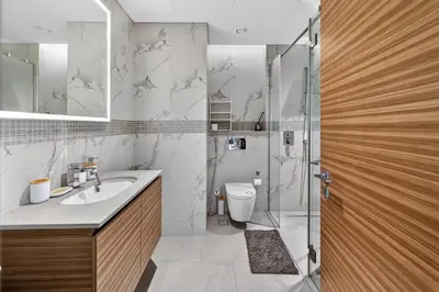 a bathroom with a shower and a toilet and a sink at One Park Avenue, Sobha Hartland 3 BR in Dubai