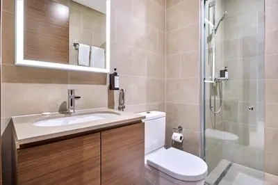 a bathroom with a toilet and a sink and a shower at STAY BY LATINEM Luxury 1BR Holiday Home CVR B 602 near Downtown in Dubai
