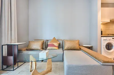 a living room with a couch and a table at STAY BY LATINEM Luxury 1BR Holiday Home CVR B 602 near Downtown in Dubai