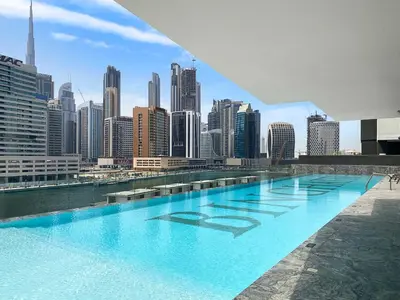 a swimming pool with a view of a city at Burj Khalifa View 2BR at Binghatti Canal in Dubai