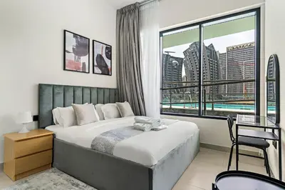 a bedroom with a bed and a large window at Burj Khalifa View 2BR at Binghatti Canal in Dubai