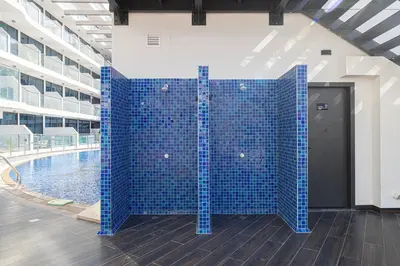 a blue tile wall next to a swimming pool at Park Views by Samana with Private Pool in Dubai