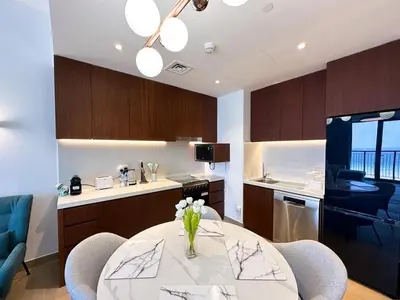 a kitchen with a table with flowers on it at NYE Firework View - Beachfront Residence - Sea View in Dubai