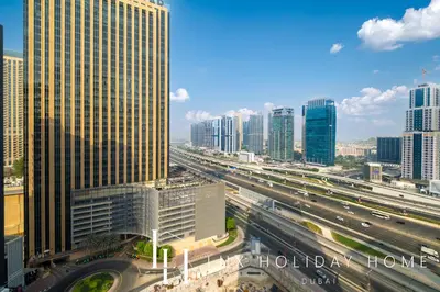 a view of a city with a highway and buildings at LUX The West Avenue Dubai Marina Suite in Dubai