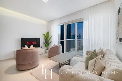a living room with a couch and chairs and a window at LUX The West Avenue Dubai Marina Suite in Dubai
