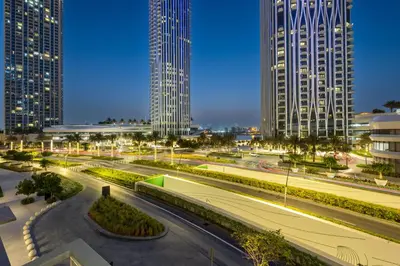 a city skyline at night with tall buildings at Creek Harbour Serenity with Burj Khalifa Glimpse in Dubai