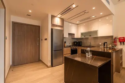 a kitchen with a refrigerator and a counter top at Spacious 2 Bedrooms with maid room I JLT in Dubai