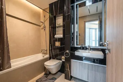 a bathroom with a toilet and a sink at Spacious 2 Bedrooms with maid room I JLT in Dubai