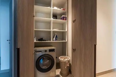 a laundry room with a washing machine in a closet at Spacious 2 Bedrooms with maid room I JLT in Dubai