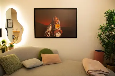 a living room with a couch and a picture on the wall at Stylish Beachfront Creek Escape in Dubai