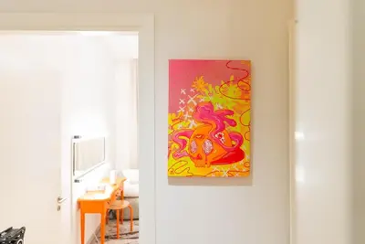 a painting hanging on a wall in a room at Stylish Beachfront Creek Escape in Dubai