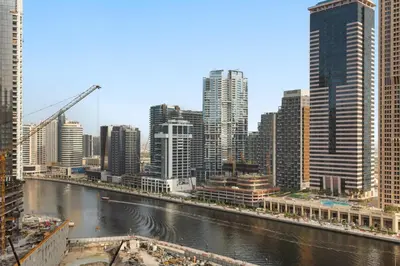 a view of a city with a river and buildings at Zarela Luxe with River Views in Dubai