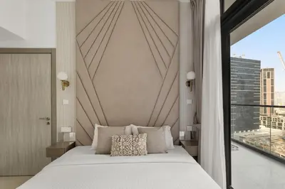 a bedroom with a large bed and a large window at Zarela Luxe with River Views in Dubai