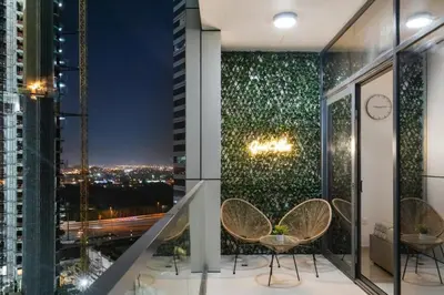 a balcony with chairs and a view of the city at Zarela Luxe with River Views in Dubai