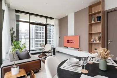 a living room with a table and a tv at GuestReady - 1BR l Canal View | Near Dubai Mall in Dubai