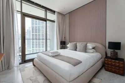 a bedroom with a large bed and a large window at GuestReady - 1BR l Canal View | Near Dubai Mall in Dubai