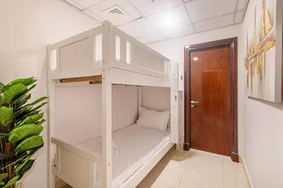 a white bunk bed in a room with a door at Luxury 3 BHK High Floor Pool, Gym Sauna Opal 2705 in Dubai
