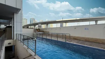 a large swimming pool on the side of a building at Luxury 3 BHK High Floor Pool, Gym Sauna Opal 2705 in Dubai