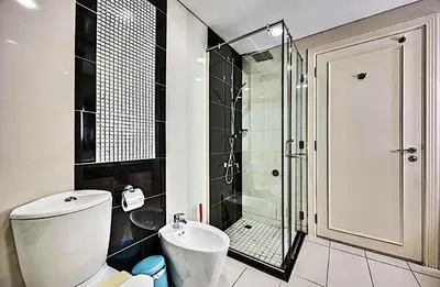 a bathroom with a shower and a toilet and a sink at Mayfair Luxury Apartment in 5-Star DAMAC Maison Mall Street Building, Downtown Dubai in Dubai