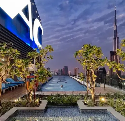 a swimming pool on the roof of a building with a city skyline at Plush & Modern 2BR Luxury stay with picturesque Rooftop 64th floor in Dubai