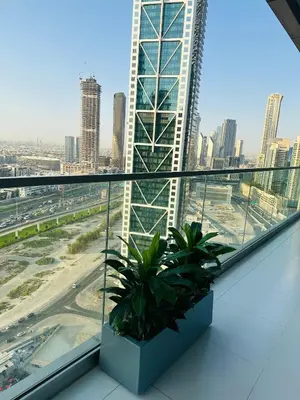a view from the top of a building with plants at Plush & Modern 2BR Luxury stay with picturesque Rooftop 64th floor in Dubai