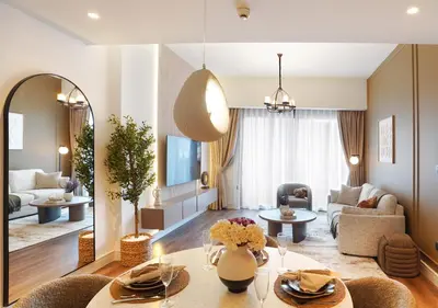 a living room with a table and a couch at Chic 2BR in Downtown, 5 Min Walk to Burj Khalifa in Dubai