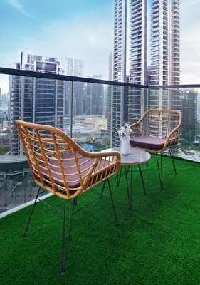 two chairs and a table on a balcony at Chic 2BR in Downtown, 5 Min Walk to Burj Khalifa in Dubai