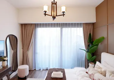 a living room with a white couch and a chandelier at Chic 2BR in Downtown, 5 Min Walk to Burj Khalifa in Dubai