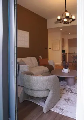 a living room with a couch and a table at Chic 2BR in Downtown, 5 Min Walk to Burj Khalifa in Dubai
