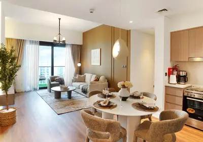 a kitchen and living room with a table and chairs at Chic 2BR in Downtown, 5 Min Walk to Burj Khalifa in Dubai