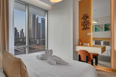 a hotel room with a bed with a view of a city at Burj View Direct to Dubai Mall 2BR in Dubai