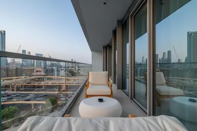 a room with a balcony with a view of a city at Burj View Direct to Dubai Mall 2BR in Dubai