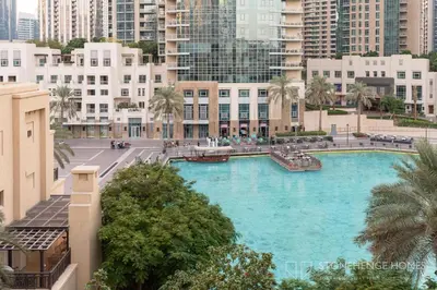 a large swimming pool in the middle of a city at Chic 1BR Apartment in Downtown Dubai Steps Away from Burj Khalifa & Dubai Mall in Dubai