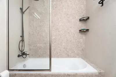 a shower with a glass door in a bathroom at Gala Guests - Serene Lakeside Residences Production City in Dubai