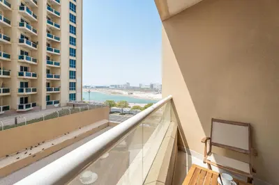 a balcony with a view of the ocean from a building at Gala Guests - Serene Lakeside Residences Production City in Dubai