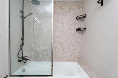 a shower with a glass door in a bathroom at Gala Guests - Serene Lakeside Residences Production City in Dubai