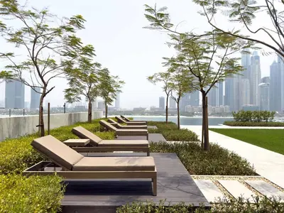 a row of chaise lounge chairs in a park at Luxury 1 Bedroom in Emaar Beach Front - Dubai Marina - Private Beach in Dubai