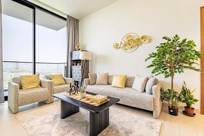 a living room with a couch and a table at Luxury 1BR in Binghatti Onyx JVC with Pool, Gym & Balcony in Dubai