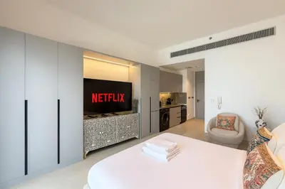 a hotel room with a netflix sign on a wall at Stylish Studio 10 Mins from Dubai Mall Meydan Area in Dubai