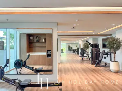 a gym with treadmills and exercise bikes in a room at LUX The Palace Residence Suite 2 in Dubai