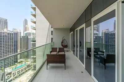 a balcony with chairs and a view of a city at Luxury 2 Bed with Iconic Burj View, Near Dubai Mall in Dubai
