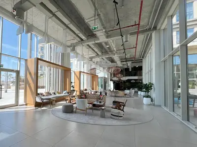 a lobby with chairs and tables in a building at Modern 1BR at Collective Dubai Hills Mall Nearby in Dubai